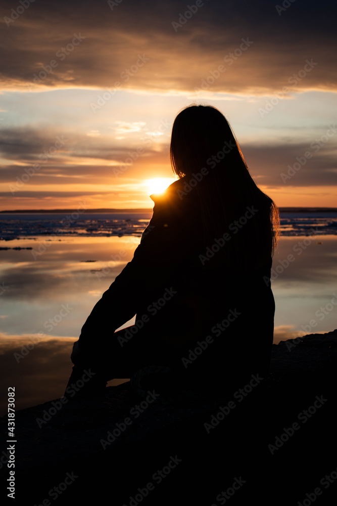 Girl on the background of a bright mirror sunset Girl on the background of a bright mirror sunset