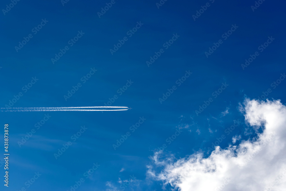 Airplane in the blue sky with clouds.