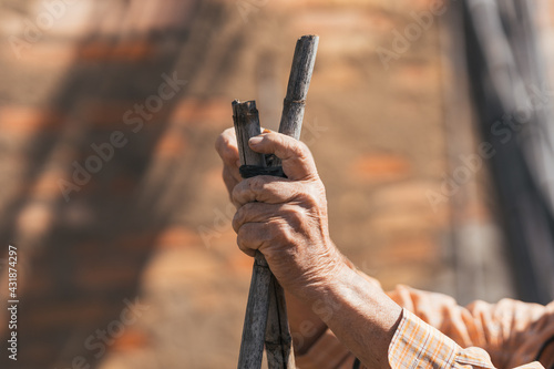 detail view of man's hands working in the field. Selective focus.