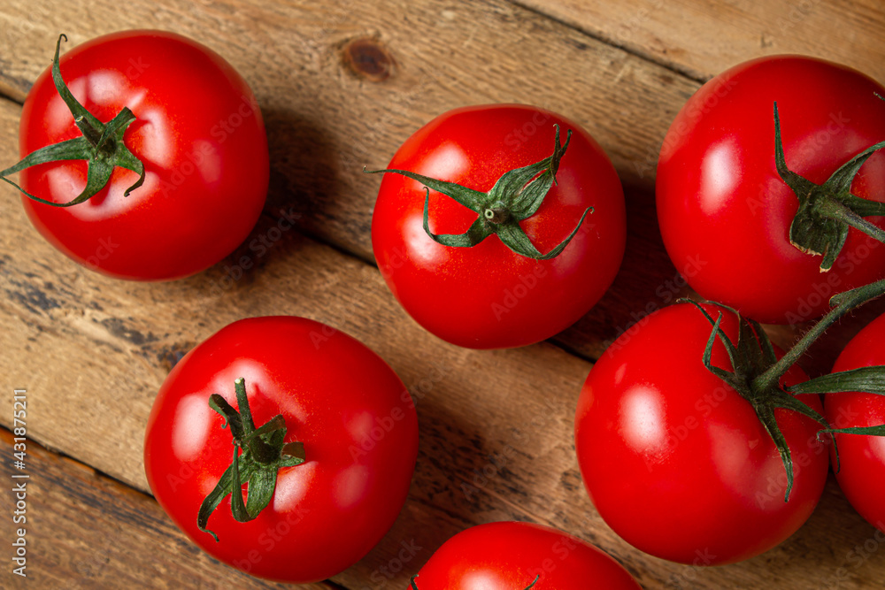 Tomatoes on a wooden background. Ripe and fresh tomatoes. Healthy vegetables. Tomatoes on a wooden background. Ripe and fresh tomatoes. Healthy vegetables.