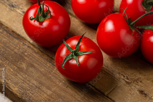 Tomatoes on a wooden background. Ripe and fresh tomatoes. Healthy vegetables.