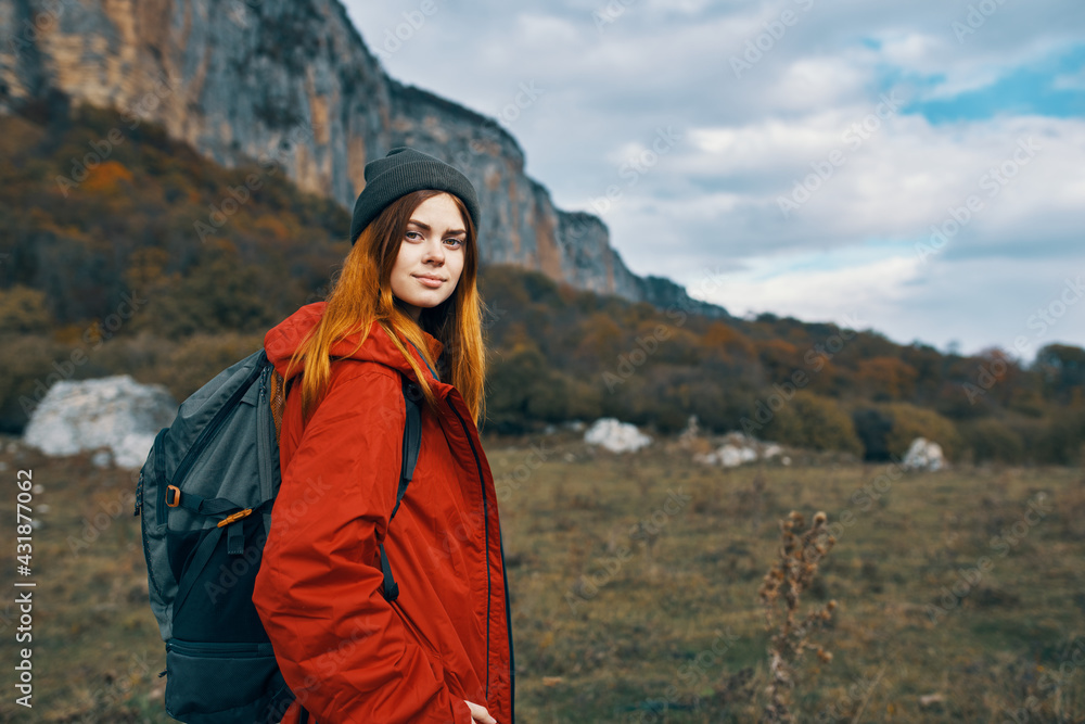 woman travels in the mountains with a backpack on her back landscape autumn warm clothes model woman travels in the mountains with a backpack on her back landscape autumn warm clothes model