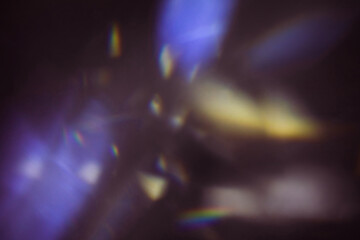 Blur colorful warm rainbow light leaks on black background with dust texture. Defocused abstract damaged scratched retro film analog effect for using over photos as overlay or screen filter