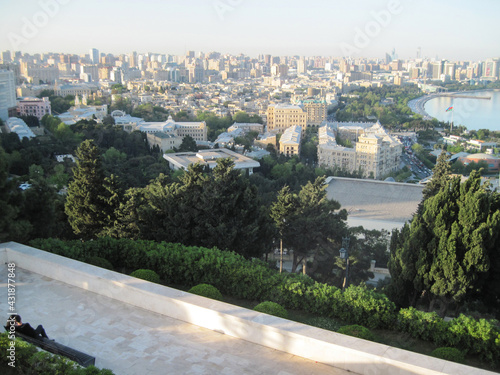 Beautiful panoramic landscape of the city in pastel colors. Scenic aerial view of Baku, Azerbaijan in the evening sun lights.