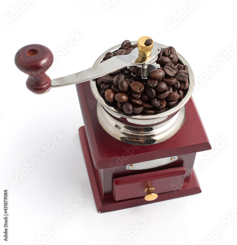 Vintage wooden coffee grinder with coffee bean on white background