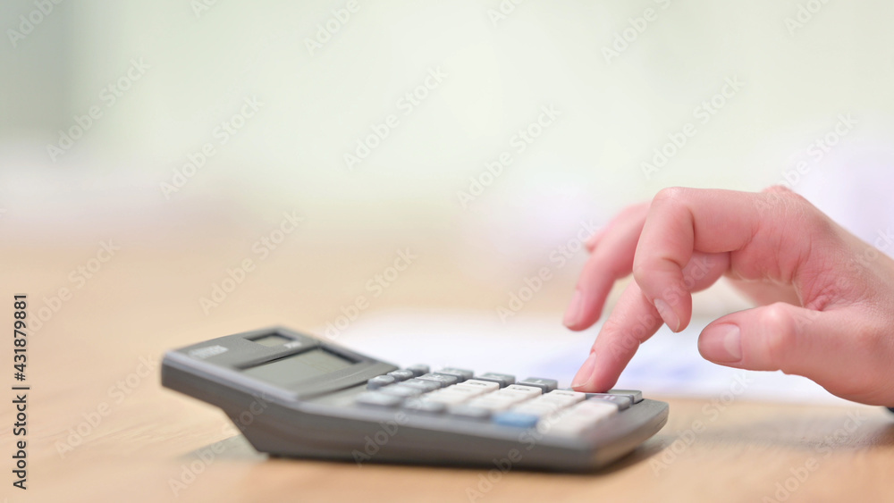 Close up of Hand Working on Calculator Close up of Hand Working on Calculator