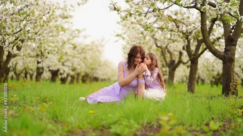 Wallpaper Mural family in purple clothe in blossoming spring garden.mom and daughter.slow motion Torontodigital.ca