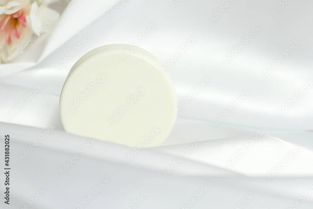 White solid soap shampoo bar on silk background, bath cosmetics