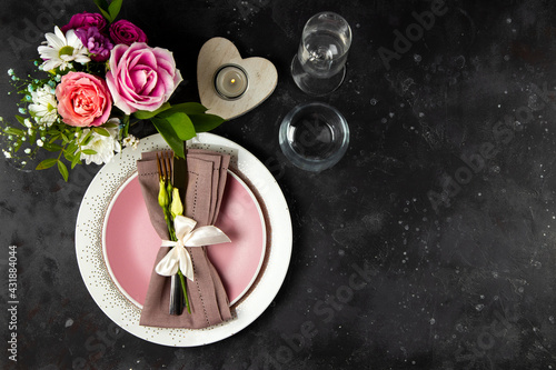  Wedding table setting concept. Plate, cutlery on linen napkin and flowers, top view, photo with copyspace
