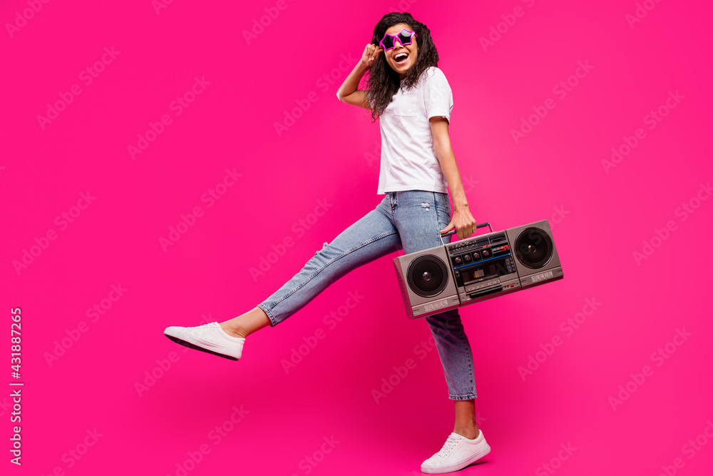 Full length body size view of lovely funny girl holding player having fun isolated over shine pink fuchsia color background Full length body size view of lovely funny girl holding player having fun isolated over shine pink fuchsia color background