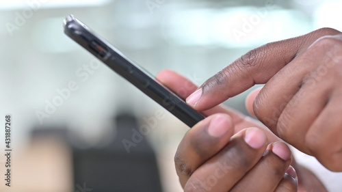 Close Up of African Hand Text Messaging on Smartphone