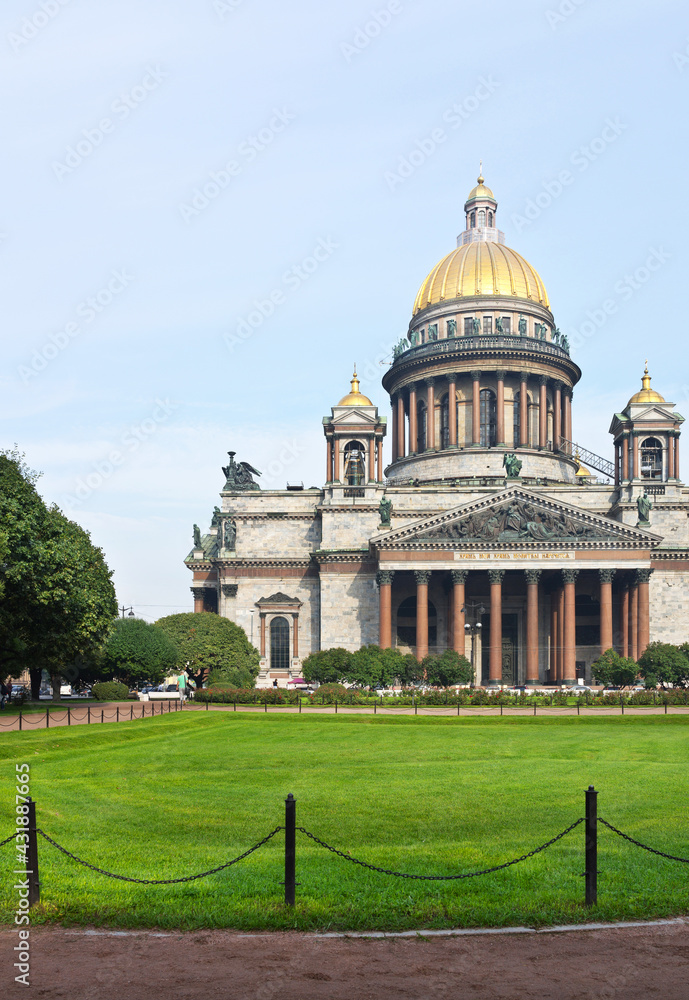 Saint  Petersburg. Facade of Saint Isaac's Cathedral or Isaakievskiy Sobor (architect Auguste de Montferrand) and Park of St. Isaac Square with a green lawn at foggy summer morning