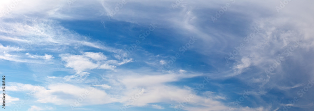 Panoramic view of layered and feathery clouds in a blue sky. Cloud cover before the weather changes. Beautiful sky landscape. Natural background of different shades of blue color