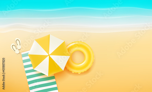 Beautiful beach with different summer stuff. Towel, umbrella, slippers and floater