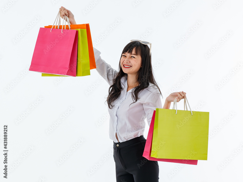 Asia woman long black hair wearing white shirt black pant with sunglasses on her head Happy with colorful paper shopping bags in hand Stand and look at the camera White background. Asia woman long black hair wearing white shirt black pant with sunglasses on her head Happy with colorful paper shopping bags in hand Stand and look at the camera White background.