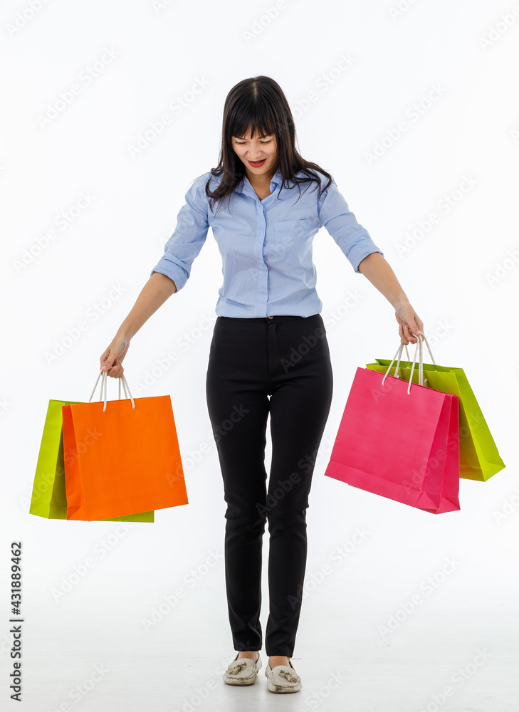 Female customer walking with very happy after shopping super discount from mall. Big smile many colorful bags in hands. Full body shot on white background. Female customer walking with very happy after shopping super discount from mall. Big smile many colorful bags in hands. Full body shot on white background.
