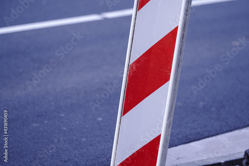 red and white striped barrier on street © Stadtrandfoto