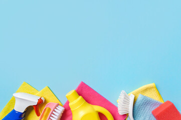 House cleaning product on blue background, copy space. Flat lay or top view. Cleaning service or housekeeping concept with space for text or design