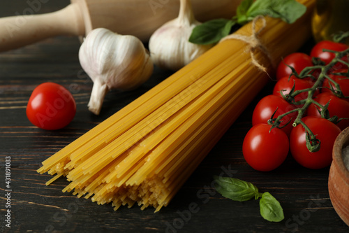 Concept of cooking tasty pasta on wooden background