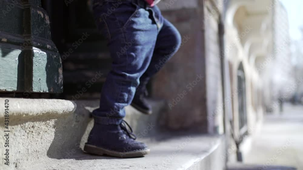 Little boy toddler stepping outside at urban city street Little boy toddler stepping outside at urban city street