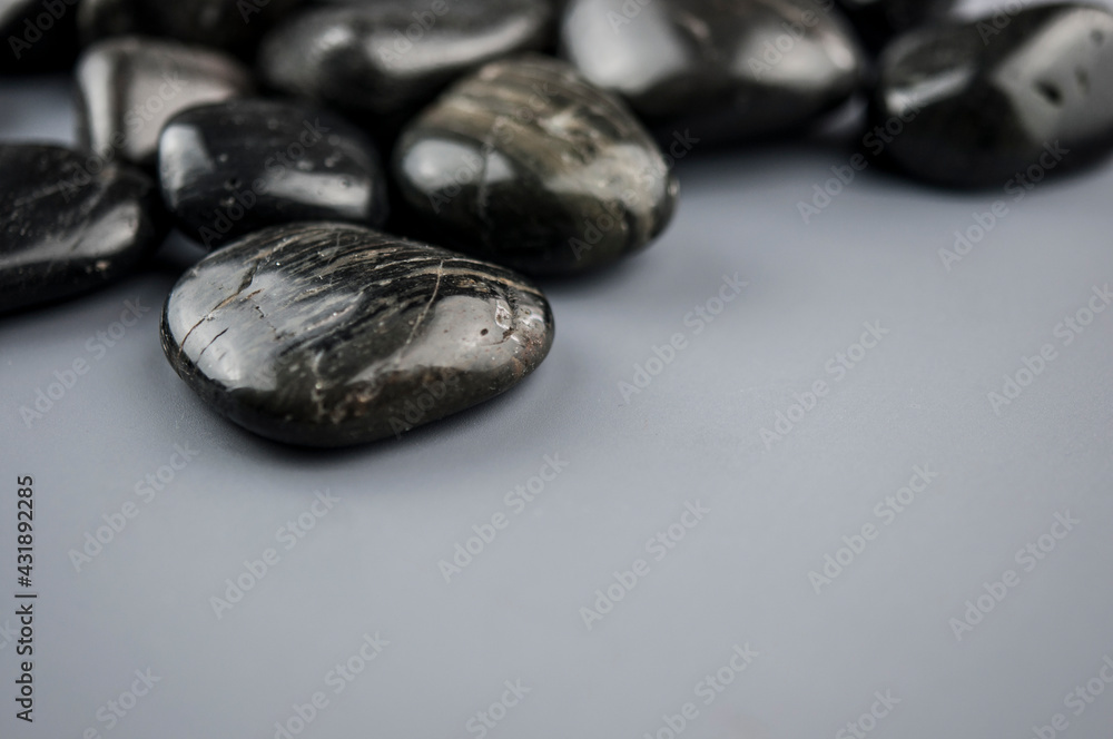 row zen stones on gray paper background row zen stones on gray paper background