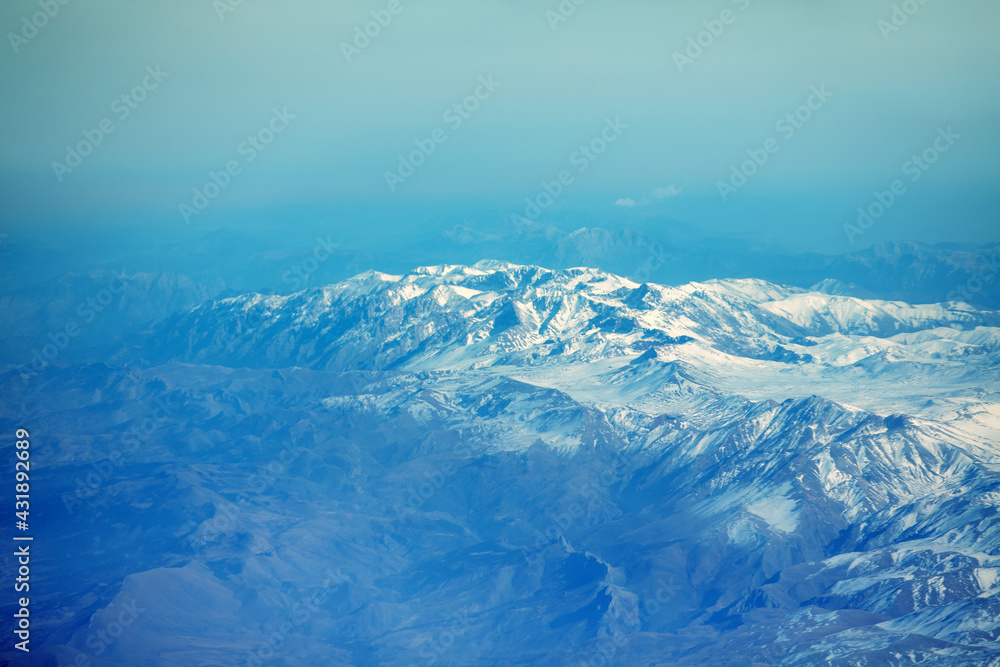 View of the snow-covered mountains from the plane