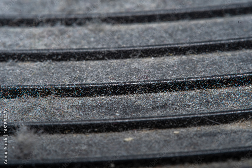 A background with an old plastic surface in soft focus at high magnification. Equipment surface covered with a thick layer of dust