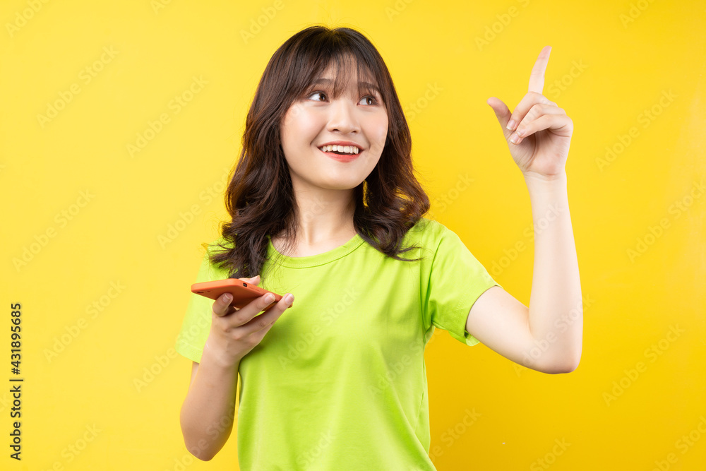 Young girl using phone with cheerful expression on background