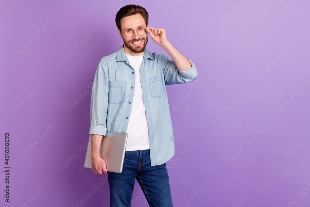Fototapeta premium Photo of attractive happy charming man wear glasses laptop smile isolated on purple color background