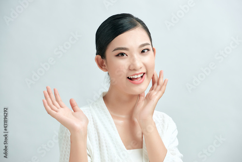 Beautiful Asian young woman touching soft cheek smile with clean fresh skin Happiness and cheerful with positive emotiona photo