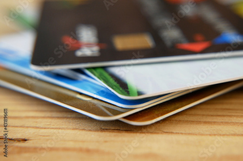 many bank's card and prepaid payment card on wooden background photo