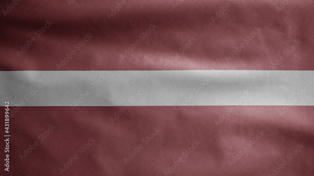 Latvian flag waving in the wind. Close up of Latvia banner blowing soft silk. Latvian flag waving in the wind. Close up of Latvia banner blowing soft silk.