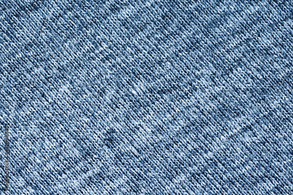 Blue wool sweater fabric. Closeup textile texture. Apparel clothes. Casual wear. Knit pattern. Warm winter fiber material. Cotton background. Blue wool sweater fabric. Closeup textile texture. Apparel clothes. Casual wear. Knit pattern. Warm winter fiber material. Cotton background.
