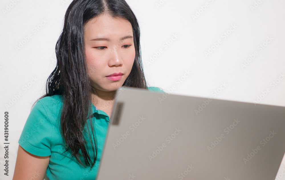home lifestyle portrait of young happy and beautiful Asian Chinese woman at home networking and studying using laptop computer on bed focused and relaxed home lifestyle portrait of young happy and beautiful Asian Chinese woman at home networking and studying using laptop computer on bed focused and relaxed