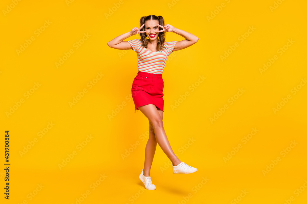 Full length photo of lady dance show v-sign wear striped shirt short skirt footwear isolated yellow color background Full length photo of lady dance show v-sign wear striped shirt short skirt footwear isolated yellow color background
