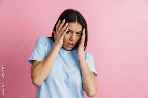 Young hispanic scared woman covering her face and looking at camera © Drobot Dean