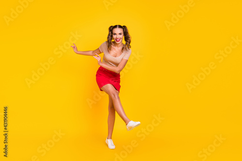 Photo of lady dance have fun wear striped shirt mini skirt footwear isolated yellow color background