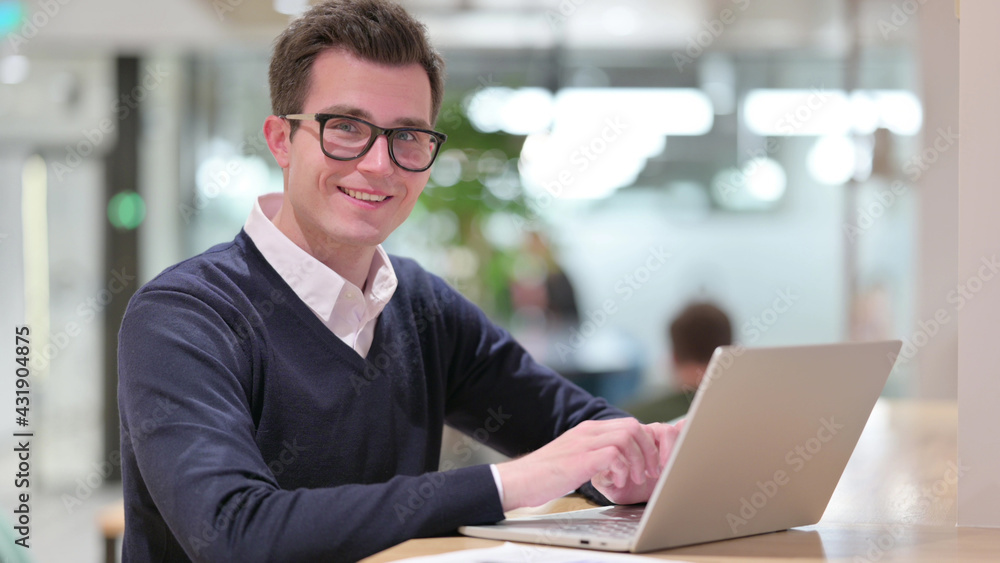 Young Businessman with Laptop Smiling at Camera Young Businessman with Laptop Smiling at Camera