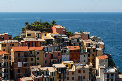 Manarola, Liguria, Italy. June 2020. Amazing view of the seaside village. The colored houses leaning on the rock near the sea are particularly fascinating and characteristic. Beautiful summer day.