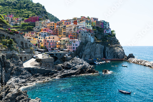 Manarola  Liguria  Italy. June 2020. Amazing view of the seaside village. The colored houses leaning on the rock near the sea are particularly fascinating and characteristic. Beautiful summer day.