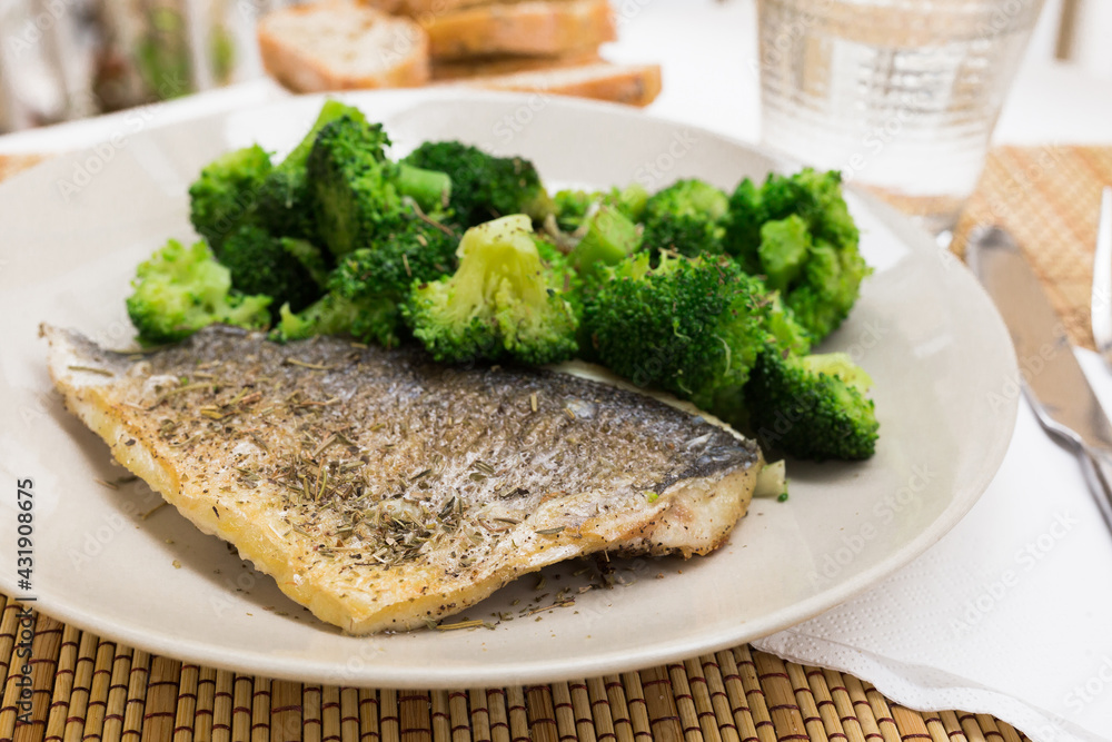 dish of fried dorado fish fillet with boiled broccoli dish of fried dorado fish fillet with boiled broccoli