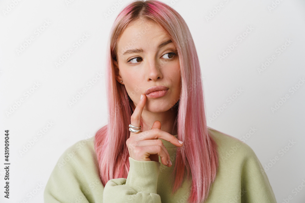 Young white thinking woman with pink hair looking aside Young white thinking woman with pink hair looking aside