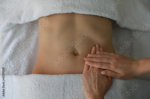 Woman receiving professional belly massage, closeup view