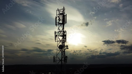 Wallpaper Mural Aerial view of the silhouette of the telecommunications tower against the backdrop of the setting sun. Wireless antenna transmitter. Cell phone, 5g 4g cellular signal radio. Torontodigital.ca