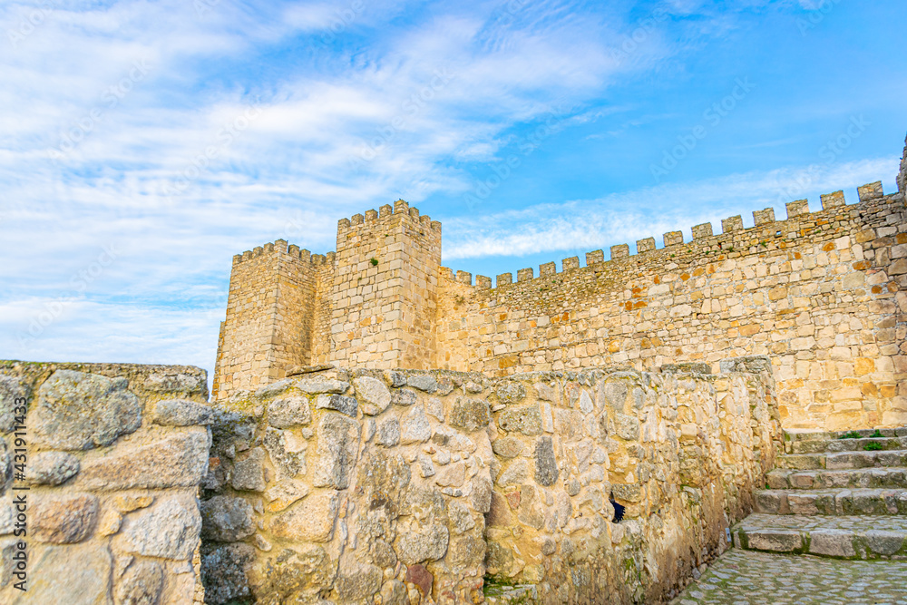 Castle of Trujillo, a medieval village in the province of Caceres, Spain in a sunny day with cloudy and blue sky.