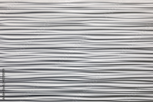 Wall texture with wavy horizontal stripes. Gray convex putty. Stylish design