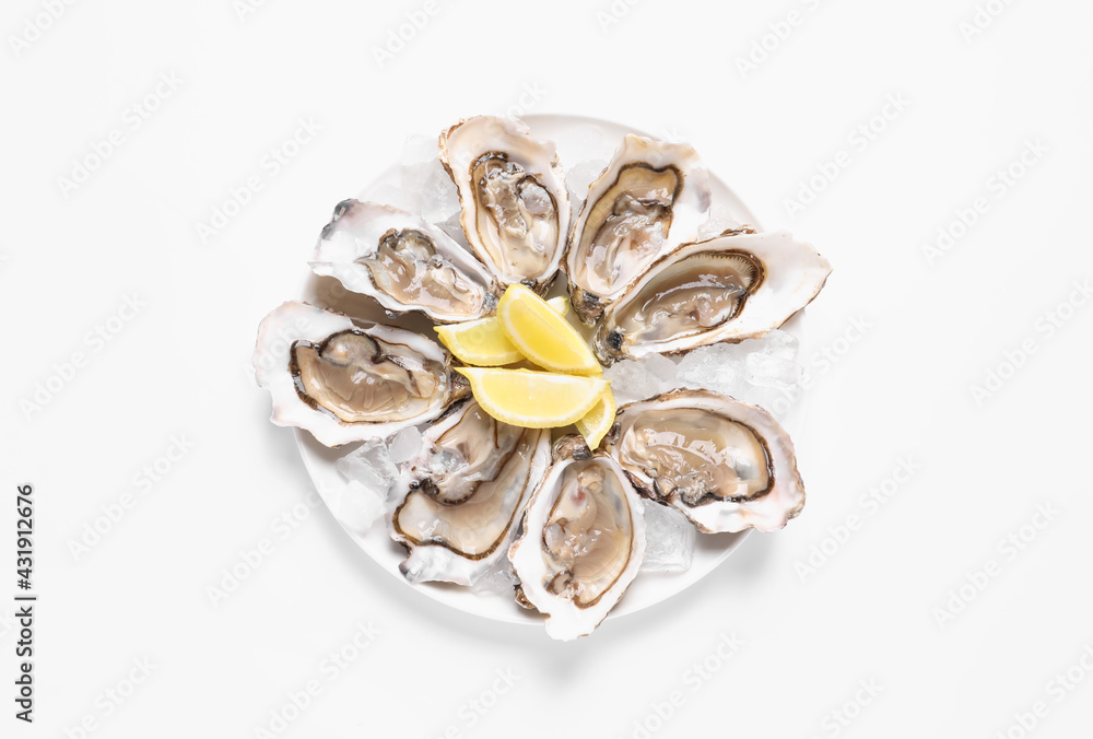Delicious fresh oysters with lemon slices isolated on white, top view Delicious fresh oysters with lemon slices isolated on white, top view