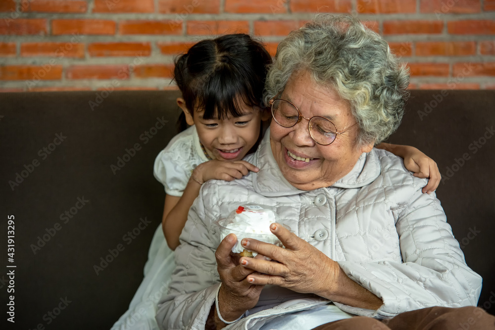Grandma gets a birthday cake from granddaughter,Giving her grandma a gift. Grandma gets a birthday cake from granddaughter,Giving her grandma a gift.