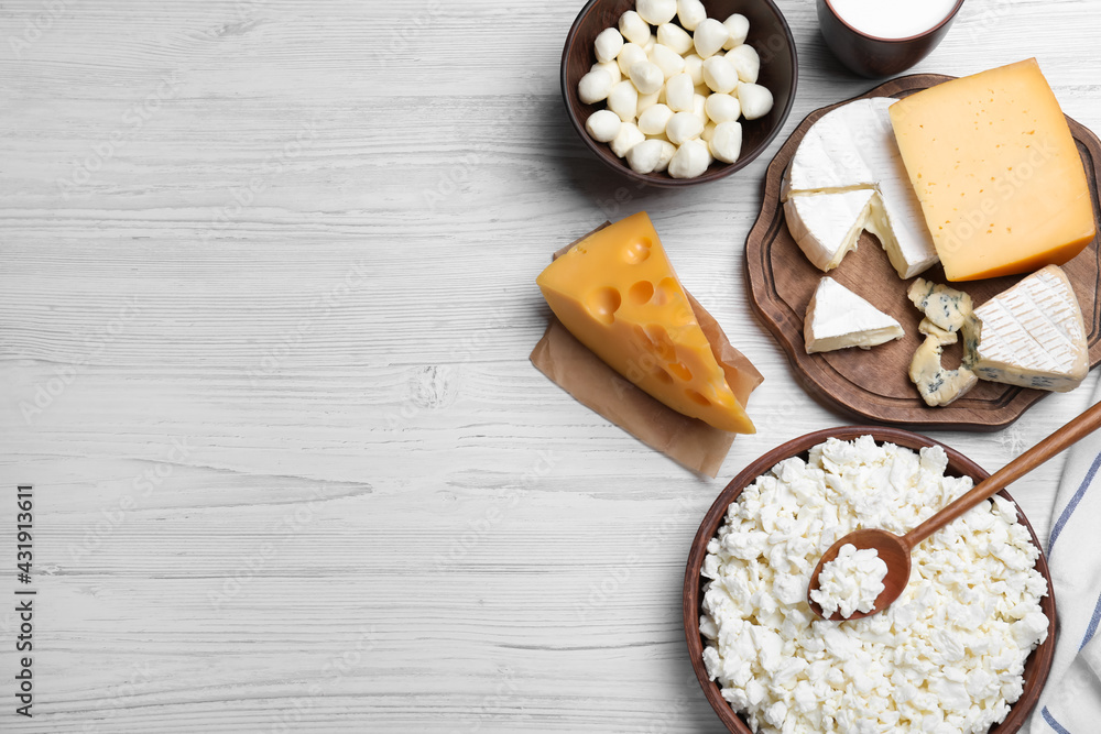 Clay dishware with fresh dairy products on white wooden table, flat lay. Space for text Clay dishware with fresh dairy products on white wooden table, flat lay. Space for text