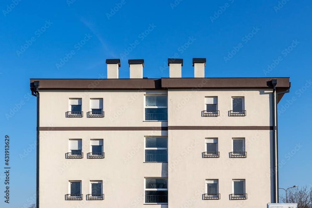 Fragment of a modern new low-rise building against the sky